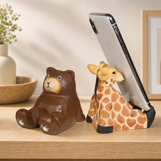 Best wooden figurines for desk displayed on a wooden workspace with laptop and plant
