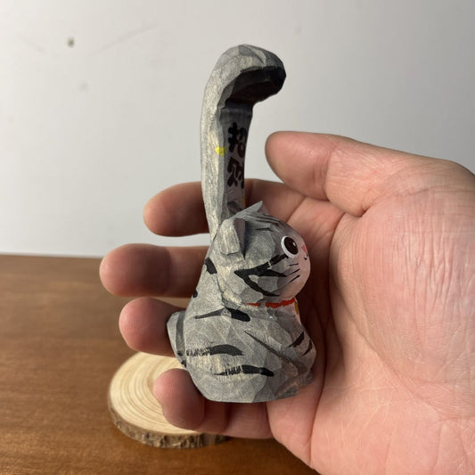 Hand-finished gray tabby lucky cat wooden figurine resting on a matching wood base