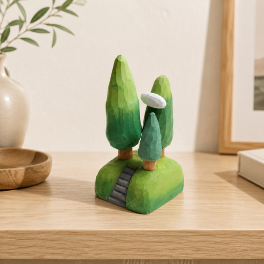 Miniature wooden scene featuring three green trees and a cloud on a stepped base