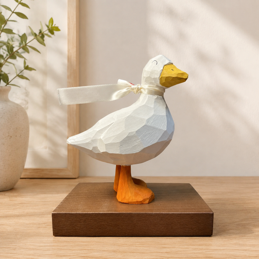Handmade-style wooden cheer up duck figurine sitting on an office work desk