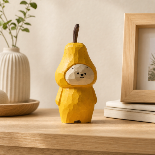 Hand-carved wooden pear character figurine with bright yellow finish on shelf