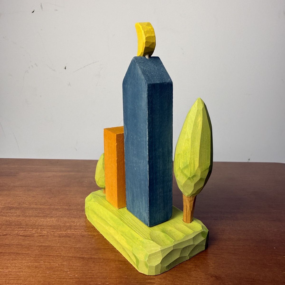 Hand-carved style wooden city towers decor set displayed on a modern office desk