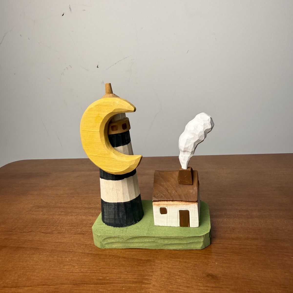 Miniature lighthouse cottage wooden scene accent displayed on a display shelf