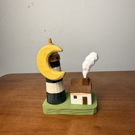 Miniature lighthouse cottage wooden scene accent displayed on a display shelf