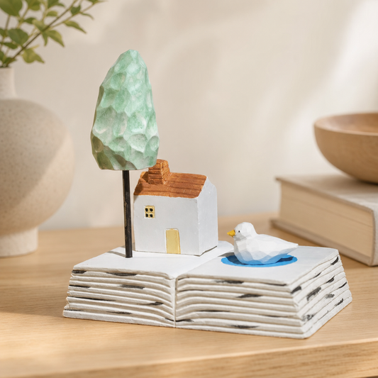Quiet days wooden miniature scene with cottage, duck, and tree on a book base
