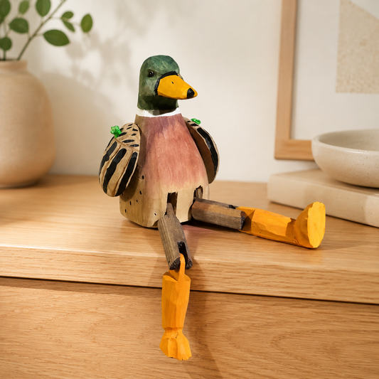 Long-leg duck wooden figurine perched on a wooden desk shelf.