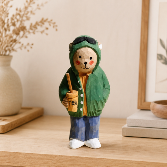 Cute wooden bear figurine wearing a green jacket and holding a milk tea cup